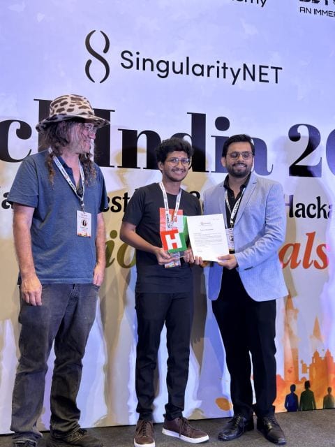 Dhadi Sai Praneeth Reddy receiving the HackIndia 2025 National Finalist trophy and certificate from Dr. Ben Goertzel of SingularityNET